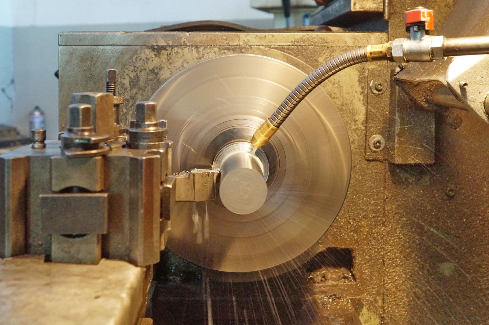 CNC turning center machining a steel shaft — precision contract manufacturing